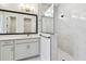 Bathroom with double sink vanity, large mirror and walk-in shower with glass partition at 11834 Mile Marsh Dr, Riverview, FL 33569