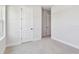 Bedroom with carpet, light walls and view of two doors at 11834 Mile Marsh Dr, Riverview, FL 33569