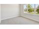 Bedroom features neutral carpet, light walls and a large window at 11834 Mile Marsh Dr, Riverview, FL 33569