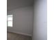 This secondary bedroom has a neutral carpet and a window to bring in natural light at 11834 Mile Marsh Dr, Riverview, FL 33569