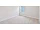Bright bedroom with neutral carpet, base molding, a window, and natural light at 11834 Mile Marsh Dr, Riverview, FL 33569