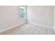 Neutral bedroom with carpet, base molding, a window, and ample natural light at 11834 Mile Marsh Dr, Riverview, FL 33569