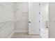 Walk-in closet with white wire shelving and view of ensuite bathroom at 11834 Mile Marsh Dr, Riverview, FL 33569