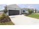 Charming single-story home with a well-manicured lawn and an attached two-car garage at 11834 Mile Marsh Dr, Riverview, FL 33569