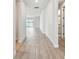 Bright hallway featuring wood floors leading to the living areas and bathroom at 11834 Mile Marsh Dr, Riverview, FL 33569