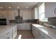 Stylish kitchen with white cabinets, sleek countertops, and stainless steel appliances at 11834 Mile Marsh Dr, Riverview, FL 33569