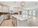 Spacious kitchen with quartz island, stainless steel appliances, stylish tile backsplash, and pendant lighting at 11834 Mile Marsh Dr, Riverview, FL 33569
