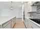 Well-designed kitchen with a quartz island, stainless steel appliances, and elegant pendant lighting at 11834 Mile Marsh Dr, Riverview, FL 33569