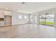 Spacious living room with sliding glass doors that open to the backyard and connect to kitchen at 11834 Mile Marsh Dr, Riverview, FL 33569