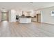 Large open concept with kitchen, living room, stylish light fixtures and stainless steel appliances at 11834 Mile Marsh Dr, Riverview, FL 33569
