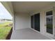 Covered patio with sliding glass doors offers an indoor-outdoor flow and backyard access at 11834 Mile Marsh Dr, Riverview, FL 33569