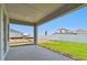 Covered patio with concrete flooring, overlooking a manicured lawn and white fence at 11834 Mile Marsh Dr, Riverview, FL 33569