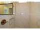 The shower features sleek bronze fixtures and marble tiling for a modern look at 11834 Mile Marsh Dr, Riverview, FL 33569