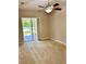 Spacious bedroom with carpet, ceiling fan, and sliding glass door to screened patio at 1201 Ventana Dr, Sun City Center, FL 33573