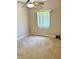 Bright bedroom with wall-to-wall carpet, a ceiling fan, and a large window offering natural light at 1201 Ventana Dr, Sun City Center, FL 33573
