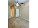 Bedroom featuring a ceiling fan and convenient access to the bathroom at 1201 Ventana Dr, Sun City Center, FL 33573