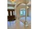Welcoming foyer with a decorative front door, tile flooring, and an elegant view of the adjacent sitting area at 1201 Ventana Dr, Sun City Center, FL 33573