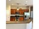 Kitchen with stainless steel appliances, wood cabinets, and a breakfast bar at 1201 Ventana Dr, Sun City Center, FL 33573