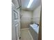 A functional laundry room featuring wire shelving, tiled floor, and washer and dryer hookups at 1201 Ventana Dr, Sun City Center, FL 33573