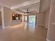 Spacious living area with tile flooring, a modern ceiling fan, and sliding glass doors to the backyard at 1201 Ventana Dr, Sun City Center, FL 33573