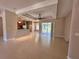 Spacious living area with tile flooring, a modern ceiling fan, and sliding glass doors to the backyard at 1201 Ventana Dr, Sun City Center, FL 33573