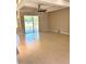 Bright and airy living room with tile flooring, a modern ceiling fan, and sliding doors to the lanai at 1201 Ventana Dr, Sun City Center, FL 33573