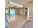 Open-concept living room with high ceilings, tile flooring, and sliding glass doors to the outdoors at 1201 Ventana Dr, Sun City Center, FL 33573
