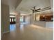 Open-concept living space featuring tile floors, decorative columns, and seamless flow to the kitchen at 1201 Ventana Dr, Sun City Center, FL 33573