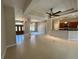 Open-concept living space featuring tile floors, decorative columns, and seamless flow to the kitchen at 1201 Ventana Dr, Sun City Center, FL 33573