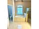 An inviting main bathroom includes a soaking tub under a bright window, and a glass-doored shower for relaxation at 1201 Ventana Dr, Sun City Center, FL 33573