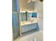 Bright main bath featuring double sinks with modern fixtures and lighting, and glass enclosed shower at 1201 Ventana Dr, Sun City Center, FL 33573