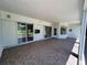 Large covered patio with tile flooring, sliding glass doors, and outdoor entertaining space at 1201 Ventana Dr, Sun City Center, FL 33573
