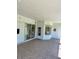 Spacious covered patio with tile flooring, access to the outdoors, and an inviting seating area at 1201 Ventana Dr, Sun City Center, FL 33573