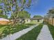Charming home featuring a long driveway and a spacious, well-maintained backyard at 1221 E Emma St, Tampa, FL 33603