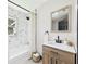 Bathroom featuring a tiled shower/tub, modern vanity, and stylish fixtures at 1221 E Emma St, Tampa, FL 33603