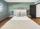 Bedroom showcasing a well-styled bed, hardwood floors, and neutral-toned decor at 1221 E Emma St, Tampa, FL 33603