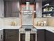 Detailed view of the kitchen showcasing designer backsplash, modern cooktop, and ample counter space at 1221 E Emma St, Tampa, FL 33603