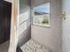 Beautifully tiled shower with a pebble floor and a window bringing in natural light at 1221 E Emma St, Tampa, FL 33603