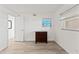 Bright bedroom with wood-look flooring, a window, and a small dresser at 1230 Gulf Blvd # 508, Clearwater Beach, FL 33767