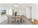 Spacious dining room seamlessly connects to a modern kitchen with white cabinets at 1230 Gulf Blvd # 508, Clearwater Beach, FL 33767