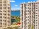 Exterior view between towers highlighting tennis courts, bay waters, and balconies at 1230 Gulf Blvd # 508, Clearwater Beach, FL 33767