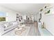 Bright living room featuring neutral decor, wood-look floors, and views into the kitchen at 1230 Gulf Blvd # 508, Clearwater Beach, FL 33767