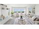 Bright, airy living room featuring neutral decor, ocean views, and hardwood floors at 1230 Gulf Blvd # 508, Clearwater Beach, FL 33767