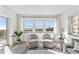 Bright living room with a pair of cozy chairs and a view of the ocean beyond at 1230 Gulf Blvd # 508, Clearwater Beach, FL 33767