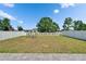 Fenced backyard featuring a well-maintained lawn, landscaping, and shade trees at 13234 Great Plains Dr, Riverview, FL 33579