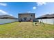 Spacious backyard with a fence, lush grass, a swing set, and ample room for recreation at 13234 Great Plains Dr, Riverview, FL 33579