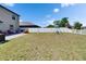 Large backyard with privacy fence, play set, lush grass, and room for outdoor fun at 13234 Great Plains Dr, Riverview, FL 33579