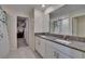 Bathroom with double vanity, granite countertops, and shower with decorative curtain at 13234 Great Plains Dr, Riverview, FL 33579