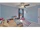 Bright bedroom with light blue walls, ceiling fan, rug, and natural light from the window at 13234 Great Plains Dr, Riverview, FL 33579