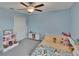 Bright, cozy bedroom with a ceiling fan and ample natural light at 13234 Great Plains Dr, Riverview, FL 33579